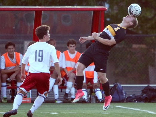 Brown Deer's Kyle Higgins heads the ball away from