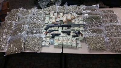 Corpus Christi police four guns, a shotgun, 45 pounds of marijuana, and more than $400,000 in cash Sunday.