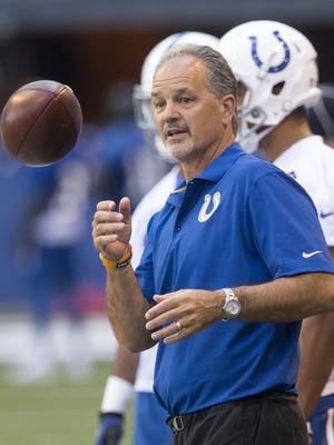 Chuck Pagano helps the defense run a drill during Colts open practice mini camp at Lucas Oil Stadium, Indianapolis, Wednesday, June 8, 2016.
