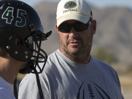Youngker coach Tony Cluff talks with a player on Monday.