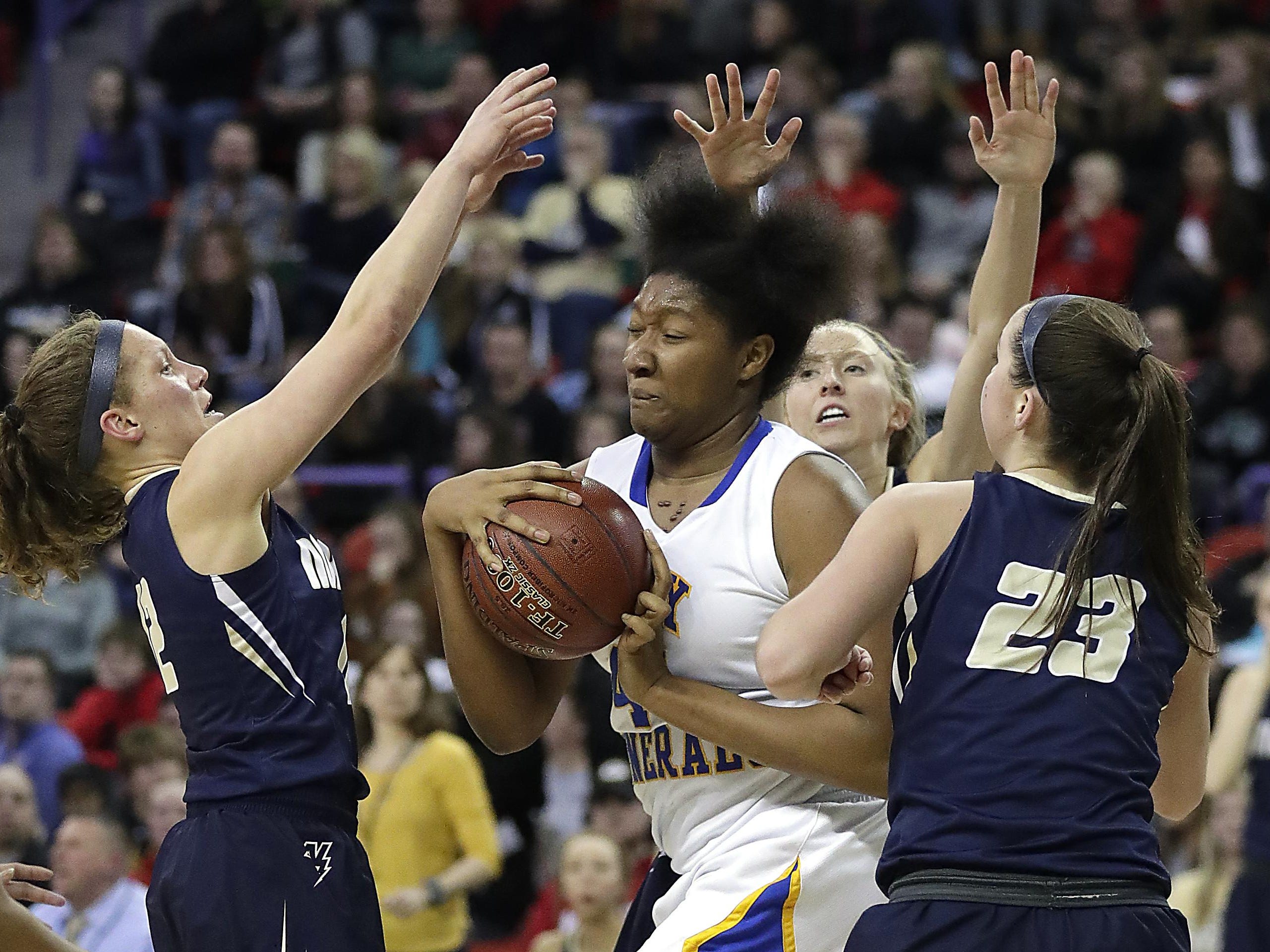 Appleton North’s Callie Pohlman, Paige Schabo and Kalen Klitzke surround Milwaukee King center Sydnee Roby under the basket in the WIAA Girls State Basketball Division 1 semifinal at the Resch Center in Ashwaubenon Friday.
