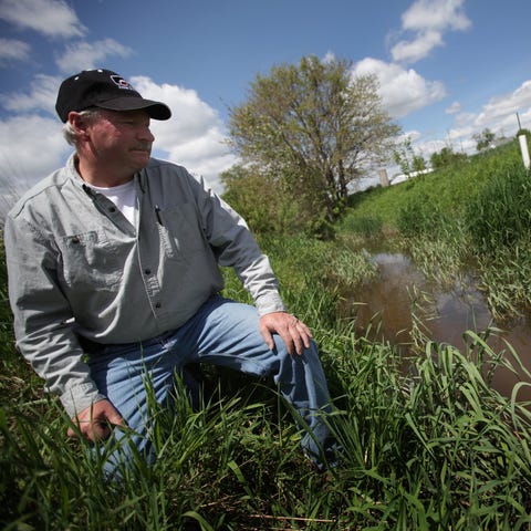 Doug Darling, 54, stands by the Amos Palmer drain...