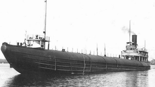 Technical diver riding a dive propulsion vehicle near the bow of the Clifton