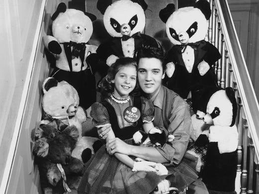 Eight-year-old Mary Kosloski had a date with Elvis Presley Jan. 8, 1958, and he kept her waiting for more than two hours. The Collierville girl, who was the national March of Dimes poster child in 1955, seemed to forgive all when Elvis appeared and told her: 'If you were 10 years older, honey, I wouldn't let you go.' The pair were photographed with teddy bears and pandas Elvis was sending to the National Foundation for Infantile Paralysis for auction during an upcoming fund drive.