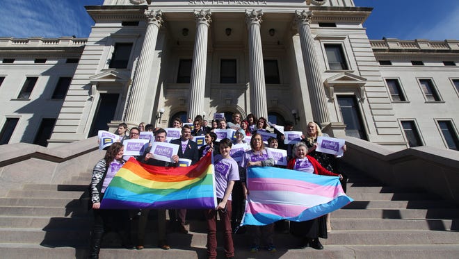 Representatives from the Center for Equality, American Civil Liberties Union of South Dakota, LGBT supporters and members of the Human Rights Campaign stand on the front steps in honor of Trans Kids Support Visibility Day at the State Capitol in Pierre on Tuesday, Feb. 23, 2016. 
