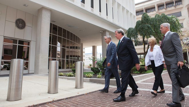 Former Wilmington Trust President Robert Harra Jr. (second from left) arrives at the federal courthouse in Wilmington in this file photo.