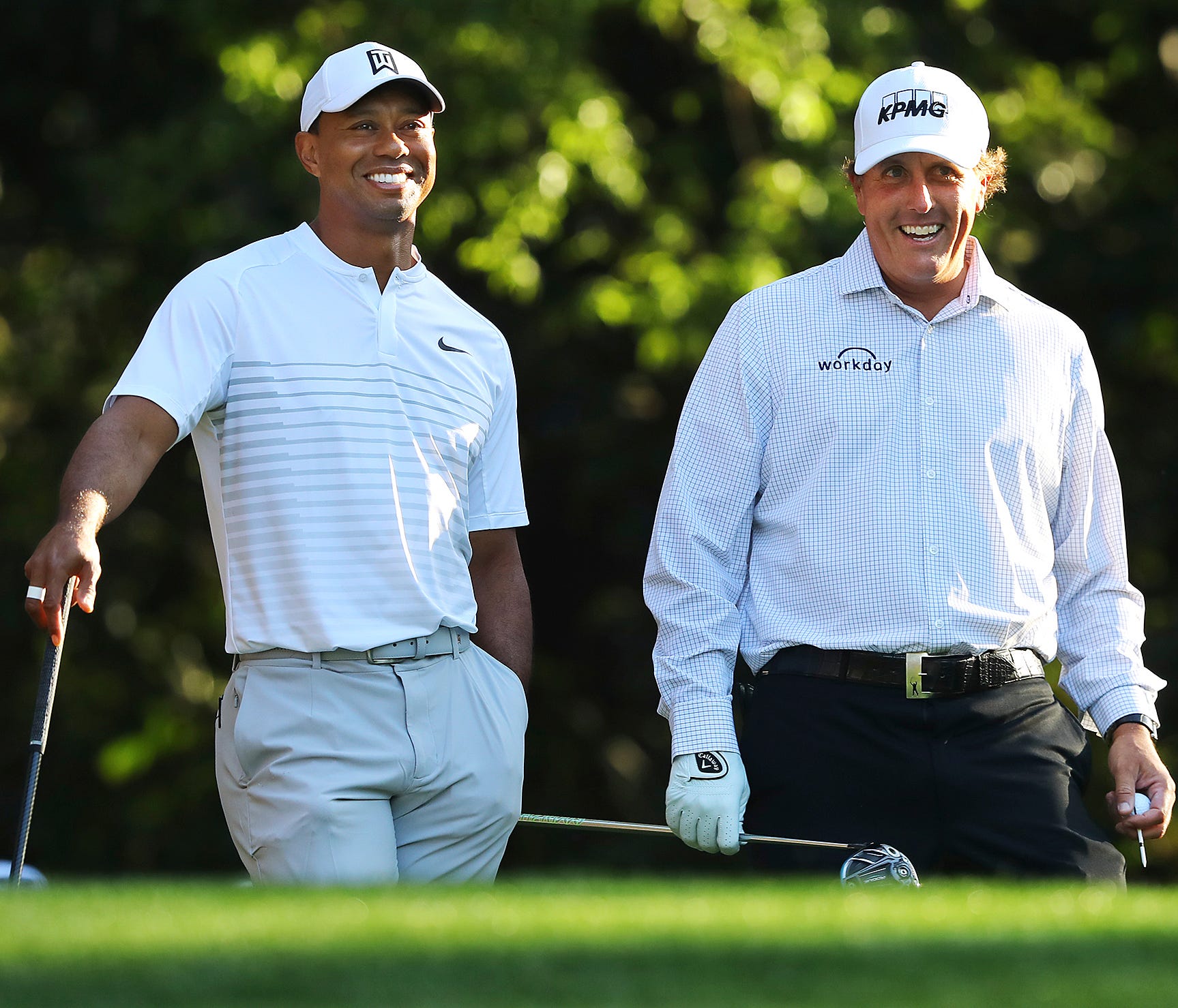 Tiger Woods, left, and Phil Mickelson share a laugh on the 11th tee box while playing a practice round for the Masters golf tournament at Augusta National Golf Club in Augusta, Ga., Tuesday, April 3, 2018. (Curtis Compton/Atlanta Journal-Constitution