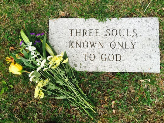 A gravestone in Middlebury where the three unknown victims of a 1935 homicide are buried.