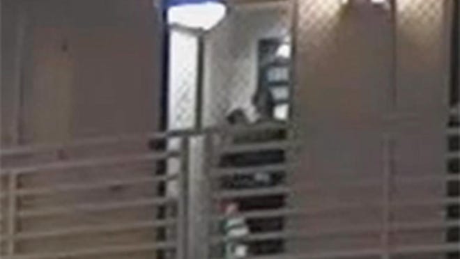Detention Officer Jerome Ulrich can be seen standing in front of an inmate in a cell at the Alachua County Jail on April 28 in this detail image from a surveillance video. Authorities say Ulrich battered the inmate and has been charged with criminal battery.