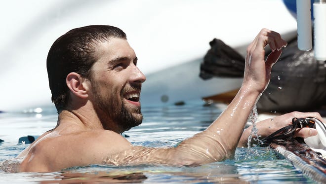 Michael Phelps reacts after finishing 17th in the Men's 400 meter freestyle prelims Friday, April 17, 2015, during the Arena Pro Swim Series at the Skyline Aquatic Center.