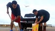 Oscar Aldana and Abraham Blanco prepare sandbags to