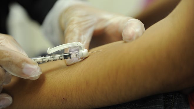 Washington, DC  -- A teen receives a vaccination for hepatitis in the forearm.