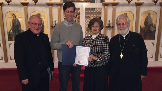 St. Catherine Greek Orthodox Church celebrated the 50th anniversary of its official church charter at the church on Nov. 21. Alderman Seph Murtagh of Ithaca’s 2nd Ward, presented an official proclamation to the church. From left, Fr. Tom Parthenakis (church pastor), Mr. Murtagh, Ann Bantuvanis (church president) and eminent Greek Orthodox theologian Rev. Dr. George Dragas, the event’s featured speaker. The church became a fully incorporated parish of the Greek Orthodox Archdiocese in 1964, receiving its official church charter from the Archdiocese in September of 1965.