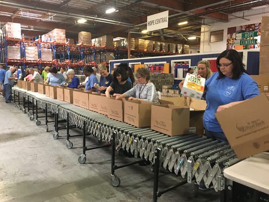 Volunteers at St. Mary's Food Bank package food boxes