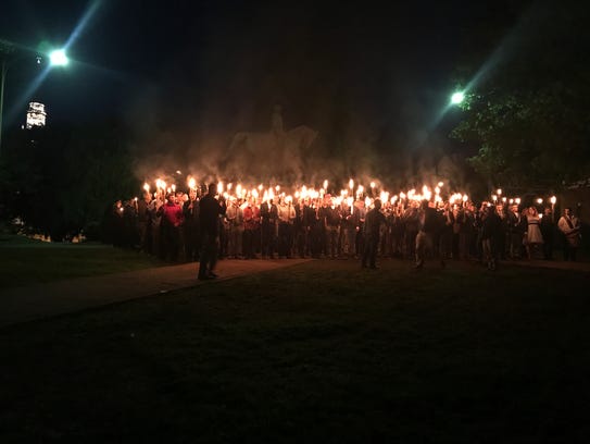 People gather at Lee Park in Charlottesville, Va.,