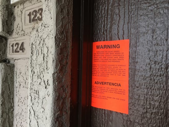 An eviction notice hangs on the front door of a Phoenix