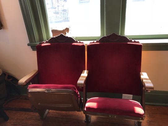 Old theater seats at the Little Goat come from the