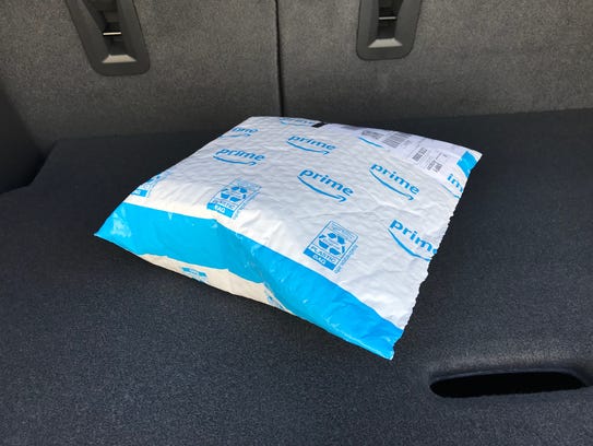 An Amazon package delivered to a customer's car using