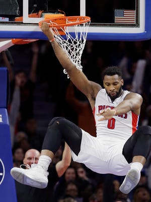 Detroit Pistons center Andre Drummond hangs from the rim after a dunk on Jan. 16, 2016, against the Golden State Warriors.