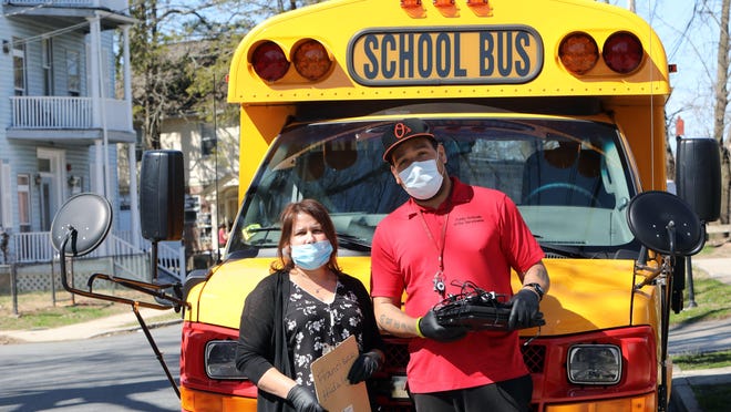 Iris Rosado and Will Cabrera, bus drivers with the Union Free School District of the Tarrytowns, delivering laptops to students that need them to do their coursework during the coronavirus pandemic April 6, 2020 in Sleepy Hollow, New York.