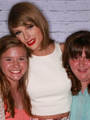 Savannah and Heather Simons pose with mega star Taylor Swift during Swift's stop at the CenturyLink Center in May.