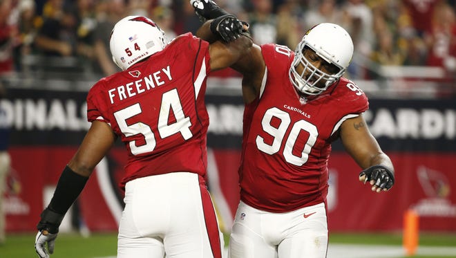 Arizona Cardinals linebacker Dwight Freeney (54, left) celebrates with Cory Redding (90) after his sack of Green Bay Packers quarterback Aaron Rodgers in the second half on Dec. 27, 2015 in Glendale, Ariz.