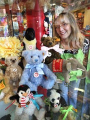 Mass Ave Toys owner Natalie Canull, who opened the independent business at 409 Mass Ave. is 2008, is shown with classic German-made Steiff teddy bears on Tuesday, July 1, 2014.