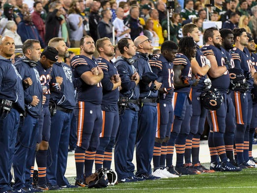 Chicago Bears players linked arms during the national