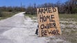 Homeowners have painted signs warning looters throughout