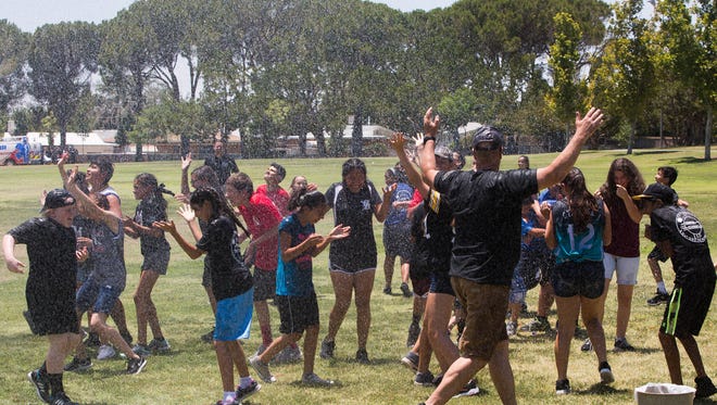 After a water balloon fight between Las Cruces Police Officers and Campers from the LCPD Youth Camp, Firefighter Wally Monsivaiz of Station One hoses off campers and officers at Young Park, Thursday, June 29, 2017. WalletHub.com recently ranked Las Cruces 32nd on the 2017 list of safest cities in America.
