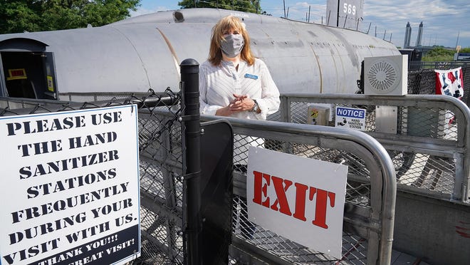 Executive Director Patti Violette exits the Albacore in Portsmouth, where they are safely conducting tours of the dry-docked submarine at Albacore Park.