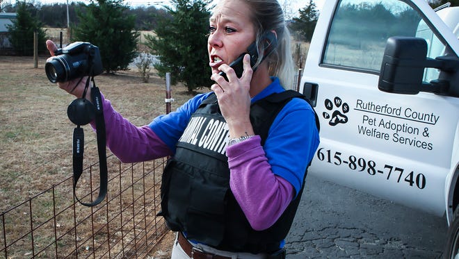 PAWS Animal Control Officer Melissa Pratt takes photos while following up on a previous complaint Nov. 21, 2016, at a home in Rutherford County.