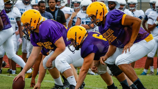 Smyrna's offensive line gets ready for a snap during Friday's scrimmage against Centennial.