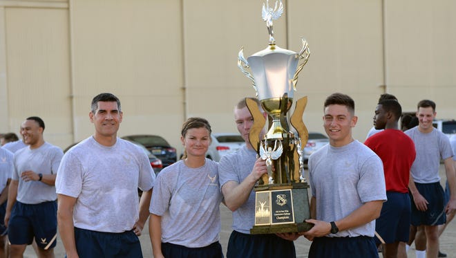 Col. Eric Shafa, 42nd Air Base Wing commander, presents a trophy to members of the 42nd Medical Group during the commander’s challenge on Maxwell Air Force Base on Aug. 26. Shafa said he created the commander’s challenge as an opportunity for the units within the 42nd ABW to work together and build camaraderie.