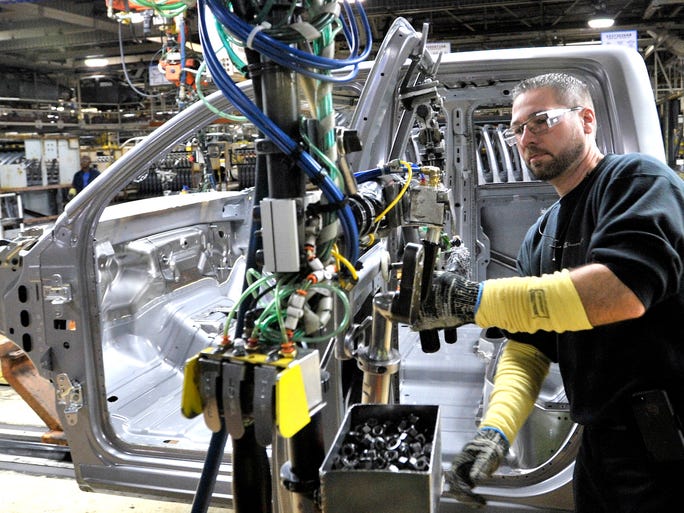 Tim Marshall of Southgate attaches the driver's door on the cab of this 2014 Ram 1500 during the Warren Truck Assembly Media Open House in Warren, Thursday, Sept.25, 2014. According to officials, this 76-year-old United Auto Workers plant is making 38,000 more vehicles this year.
