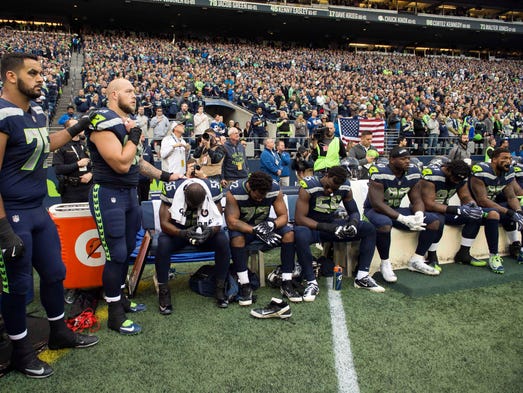 Seattle Seahawks players sit on the bench during the