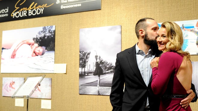 Embrace Your Body
Project Reveal creator Stacey Godbold receives a smooch from husband James Godbold during the nonprofit's Embrace Your Body Gallery Gala. The event featured more than 40 inspiring photos of area women at the Arts Council of Southwest Indiana.