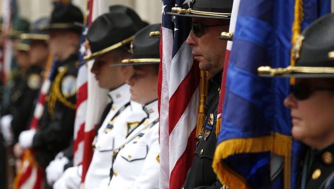 Honor guard officers line the Capitol Courtyard during the Fraternal Order of Police's 34th Annual Law Enforcement Officers' Memorial on Monday.