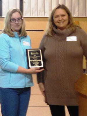 Cheryl Laatsch, left, of Higher Grounds, accepts her business award from Liz Darner, president of Discover Dodge.