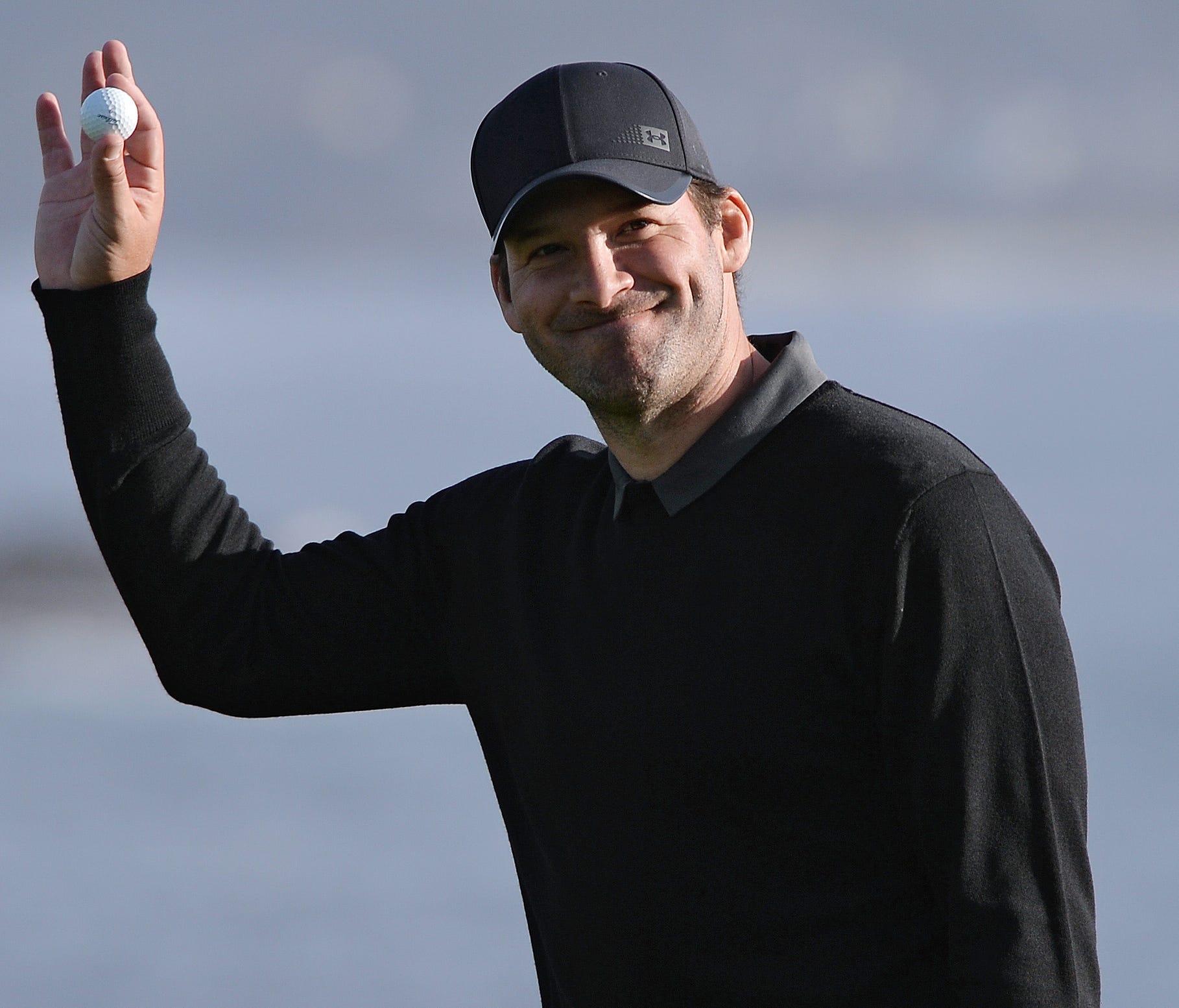 Tony Romo acknowledges the crowd on the 18th green at the 2018 AT&T Pebble Beach Pro-Am golf tournament at Pebble Beach Golf Links.