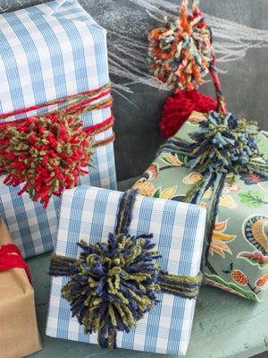 Colorful yarn pom-poms adorn gift packages.