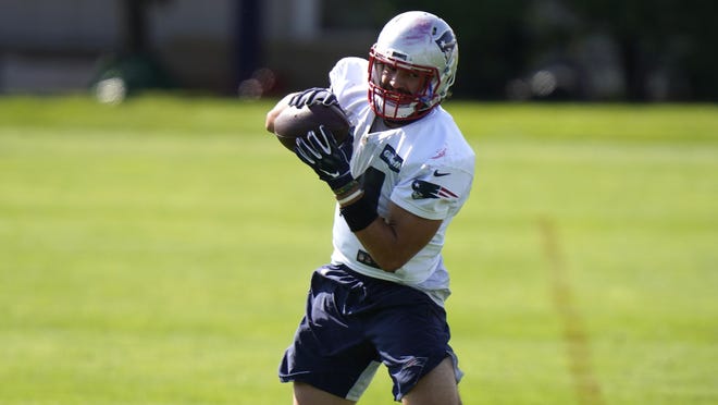 Patriots rookie tight end Dalton Keene advances the ball down the the field after catching a pass during a training camp drill Wednesday in Foxboro.