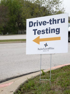 People use a drive-thru coronavirus testing station at Baylor Scott & White Clinic last month in Round Rock. More than 500 people qualified for testing through Austin&rsquo;s public testing portal since Thursday.