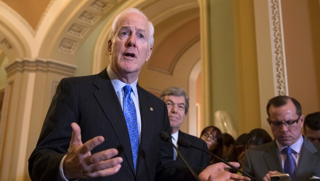Senate Majority Whip John Cornyn answers a question during a news conference on Capitol Hill on Nov. 7, 2017.