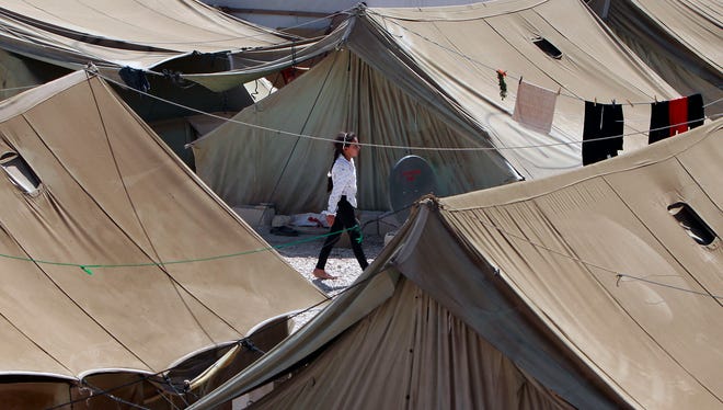 A Syrian refugee walks at a temporary  camp in the eastern Lebanese town of Marj near the border with Syria on Aug. 28.