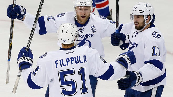 Lightning center Valtteri Filppula (51) celebrates with center Steven Stamkos (91) and center Alex Killorn (17) after scoring a goal against the New York Rangers during the second period of Game 5 of the Eastern Conference finals  Sunday in New York.