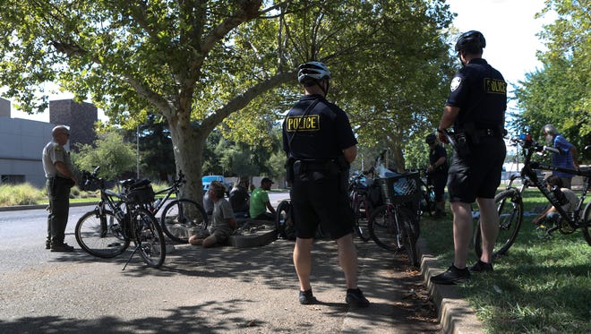 Members of the Redding Police Department and Shasta County Sheriff's Department conduct searches and make arrests Thursday at South City Park in Redding.