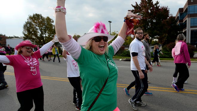 Participants cheer during the Susan G. Komen Race for the Cure on Oct. 25, 2014, in Brentwood.
