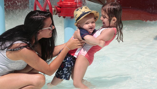 Joey Pellicano, of New Rochelle, cools off her son, Santino, 8-months-old, and daughter, Ava, 3, at the Saxon Woods pools Monday in White Plains.
