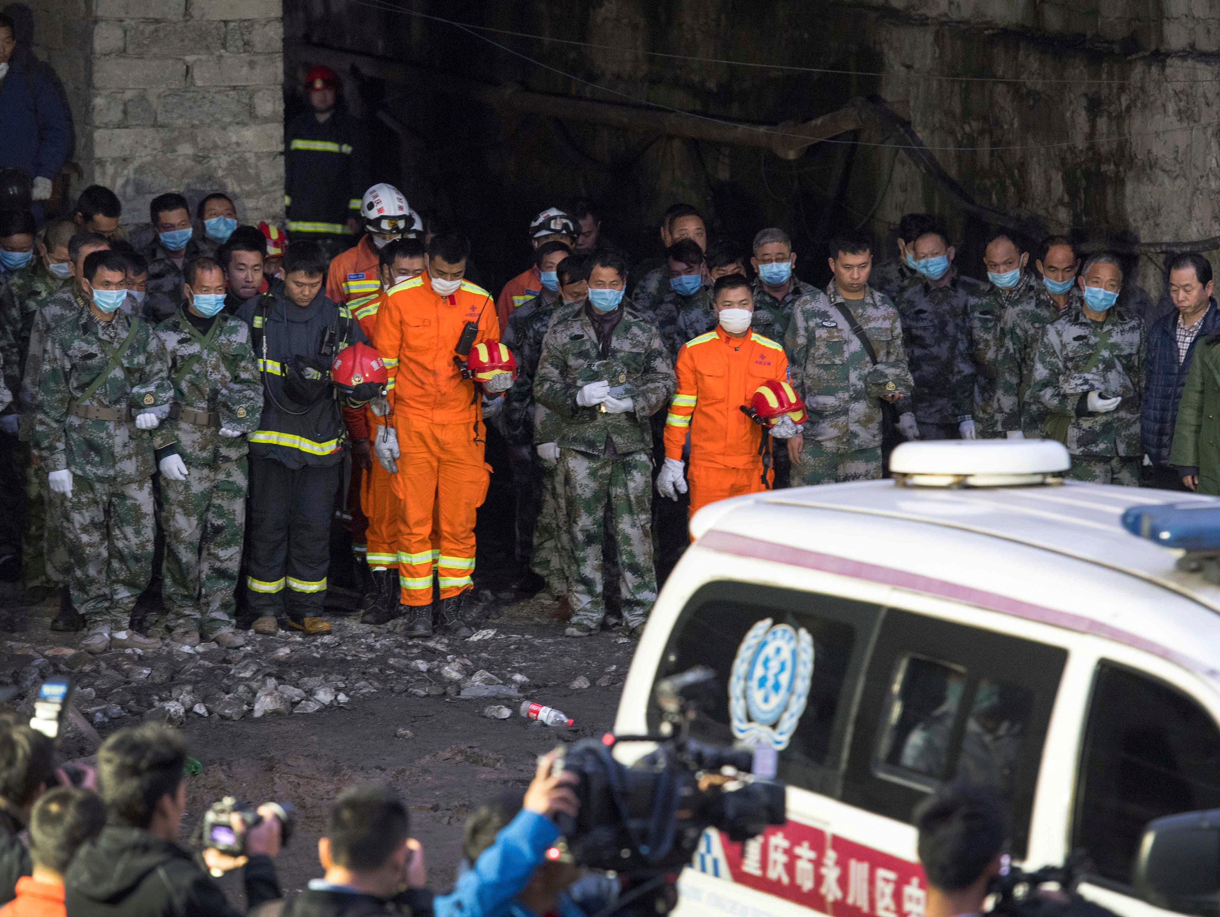 In this Tuesday, Nov. 1, 2016 photo released by Xinhua News Agency, rescuers mourn for victims at Jinshangou Coal Mine in Chongqing, southwest China.